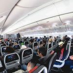 Cockpit Rush Panic — Then This Twist Airplane cabin with passengers seated in economy class