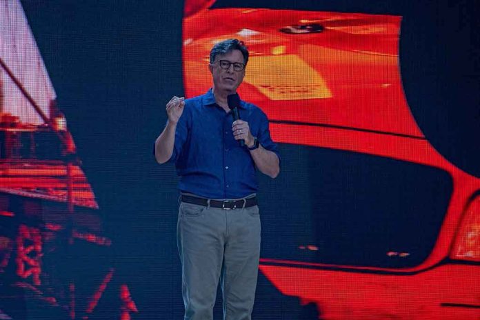 shutterstock_2029189379 Stephen Colbert speaking on stage with a microphone