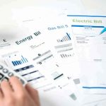 Congress Targets Data Centers Over HIGH Electric Bills Hands reviewing utility bills with calculator and pen