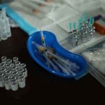 Medicine Depots Obliterated — Care Goes Dark Medical syringes and vials arranged on a table