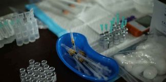 Medical syringes and vials arranged on a table