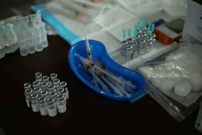 shutterstock_2064455483 Medical syringes and vials arranged on a table