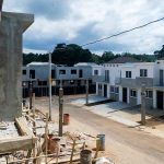 265 New Home Builds STOPPED Because Of THIS?! Row of newly built townhouses on a construction site