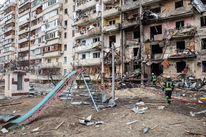 shutterstock_2129012939-1 Damaged apartment building behind a playground slide