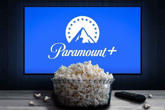 shutterstock_2166969557 Glass bowl of popcorn in front of Paramount+ on TV