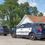 Mail Carrier’s House of Horrors Two police SUVs parked near a suburban house