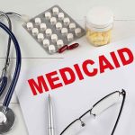 Medicare-Powered Empire, Murky Payouts Medicaid document with stethoscope and medications on desk