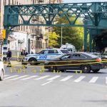 NYC’s Kids, More Guns Police cars block a city intersection with yellow crime scene tape