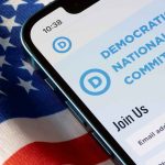 Outrage Erupts: DNC Sinks to New Low Smartphone showing a political committee webpage on an American flag