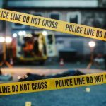 Mayor Accused of $1.5M Fraud Suddenly ‘Doesn’t Speak English’ police tape cordons off a dimly lit crime scene alley