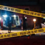 Masked Vigilante Tapes Men To Poles Police tape cordons off a dimly lit crime scene