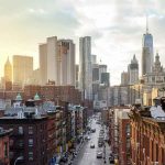 Appeals Court Revives Mamdani’s Controversial Luxury-Home Tax City street leading to a skyline of modern and historic skyscrapers at sunset