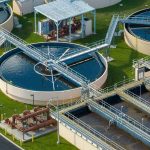 Toxic Sewage Crisis DROWNS California Beaches Wastewater treatment plant with circular clarifiers and aeration tanks