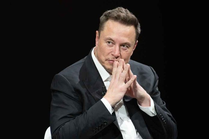 Elon Musk seated in a dark setting with hands steepled near his face