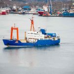 CIA’s Fake Mining Ship Hides Jaw-Dropping Heist Blue research vessel in harbor with orange cranes