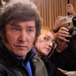 Argentinian President UN Attack Was Only Half the Story Man surrounded by reporters with cameras and phones