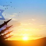 Israeli flag with silhouetted missiles at sunset