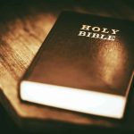 Child-Trafficking Summit UNVEILS Shocking Allies Holy Bible on a wooden table