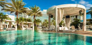 Resort pool with cabana and palm trees