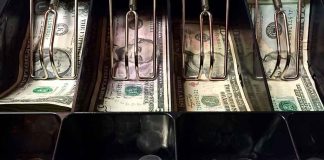 Cash register drawer with US bills and coins