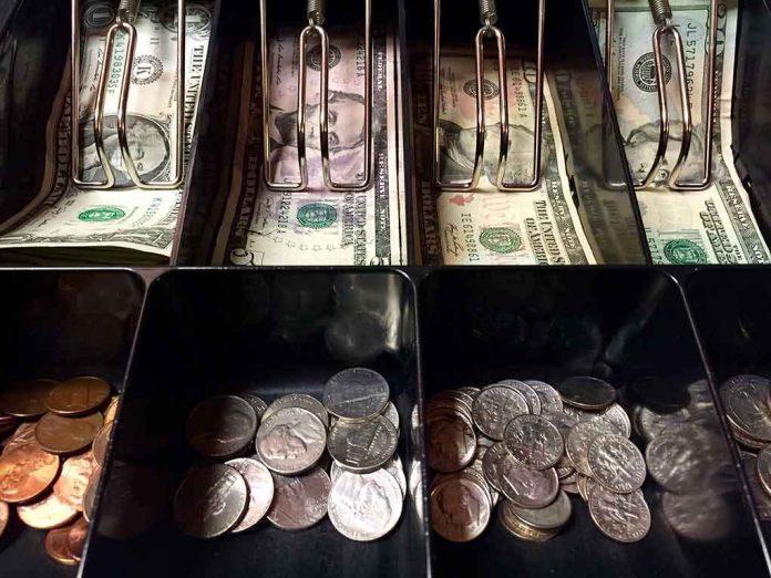 Cash register drawer with US bills and coins