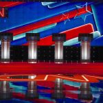 Nazi Tattoo, Deleted Sexts — CNN Meltdown Debate stage with four podiums and colorful star backdrop