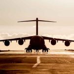 UPS Horror: Engine Rips Off, Explodes Mid-Air Large cargo aircraft on runway at sunrise