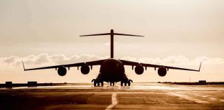 Large cargo aircraft on runway at sunrise