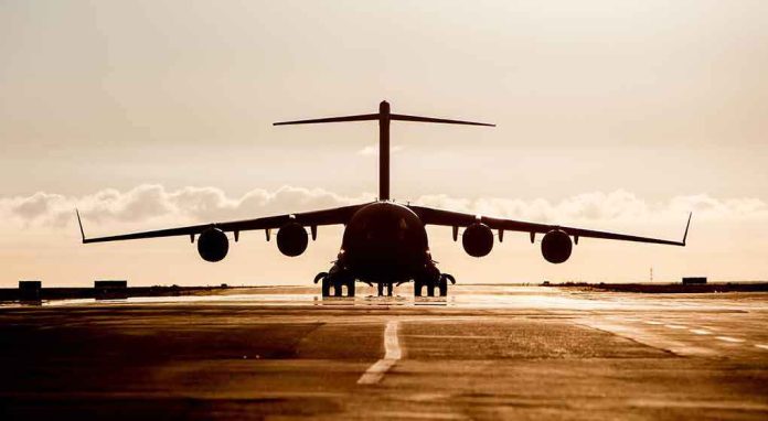 shutterstock_467492654 Large cargo aircraft on runway at sunrise