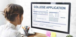 Student completing a college application on a desktop computer