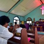 Congregation inside a church with a speaker at the pulpit