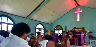Congregation inside a church with a speaker at the pulpit