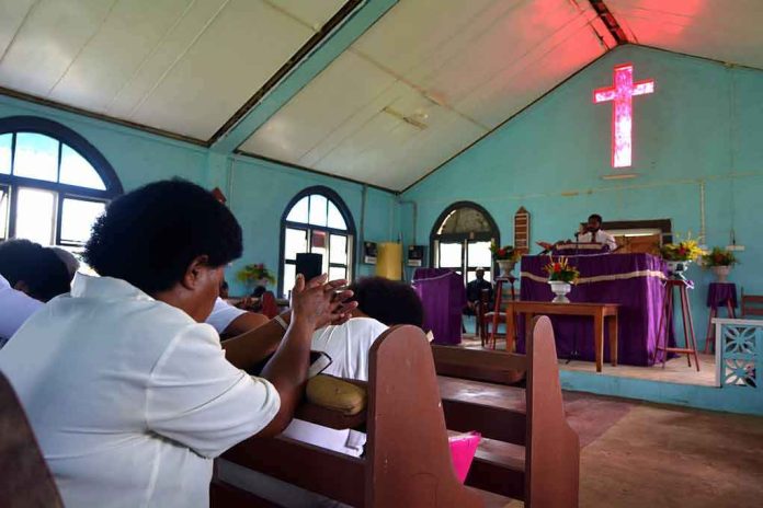 Congregation inside a church with a speaker at the pulpit