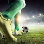 World Cup Star Dies—Cause Still a Mystery Soccer player in green socks about to kick a ball on a stadium field