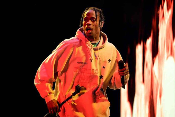 shutterstock_1142341004 Performer in a hoodie holding a microphone on stage