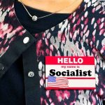 5 Democrats Just Landed on a Political HIT LIST Person wearing patterned cardigan with a name badge on chest