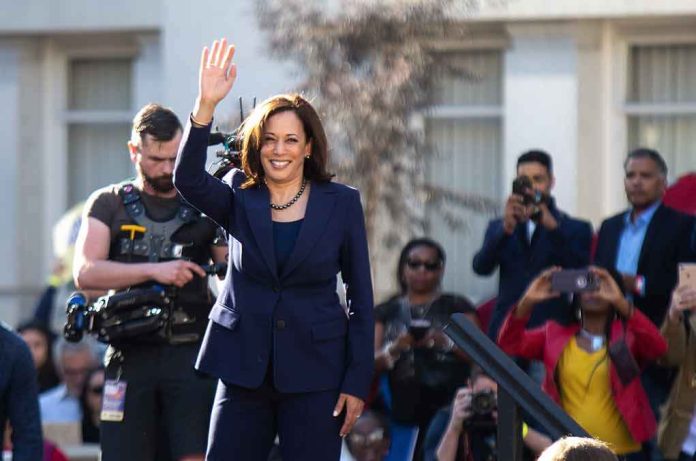 shutterstock_1296858898 Kamala Harris waves to a crowd at an outdoor event