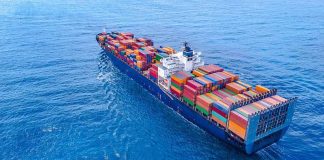 Container ship carrying colorful cargo containers at sea