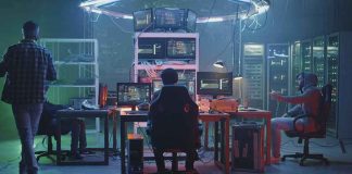 People working at computers in a dim server room