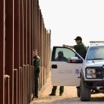 Trump DOJ Takes Border WALL Fight to Supreme Court Border patrol agents near a tall fence and a marked pickup truck