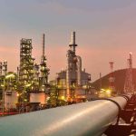 Why Your Gas Prices Could Finally DROP Oil refinery with pipelines at sunset