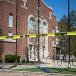 Teen FALLS From Moving Carnival Ride Playground swings blocked with caution tape in front of a brick school