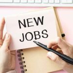 September Jobs Report MISSES by a Mile hands holding a note card over a desk with new jobs written on it