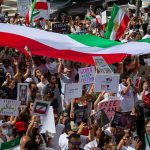 Iran Executes More Young PROTESTERS Protest crowd with flags and signs; Seyed Ebrahim Raisi, La Parka, Brian Robiskie, Philly Brown, Miguel Francisco Barragán Andrade present