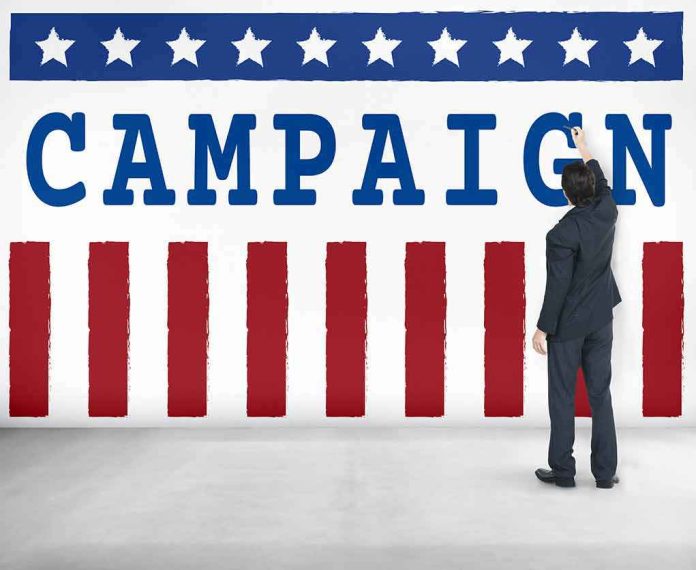 shutterstock_486646441 Man in suit writing on large campaign banner with stars and stripes
