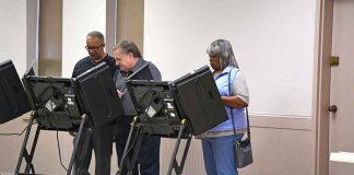 Lester Bowie and Miriam Tlali using electronic voting machines at a polling place